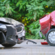Damaged in heavy car accident vehicles after collision on city street crash site