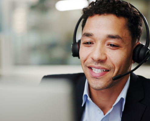 Man, call center and computer in office with smile for contact us